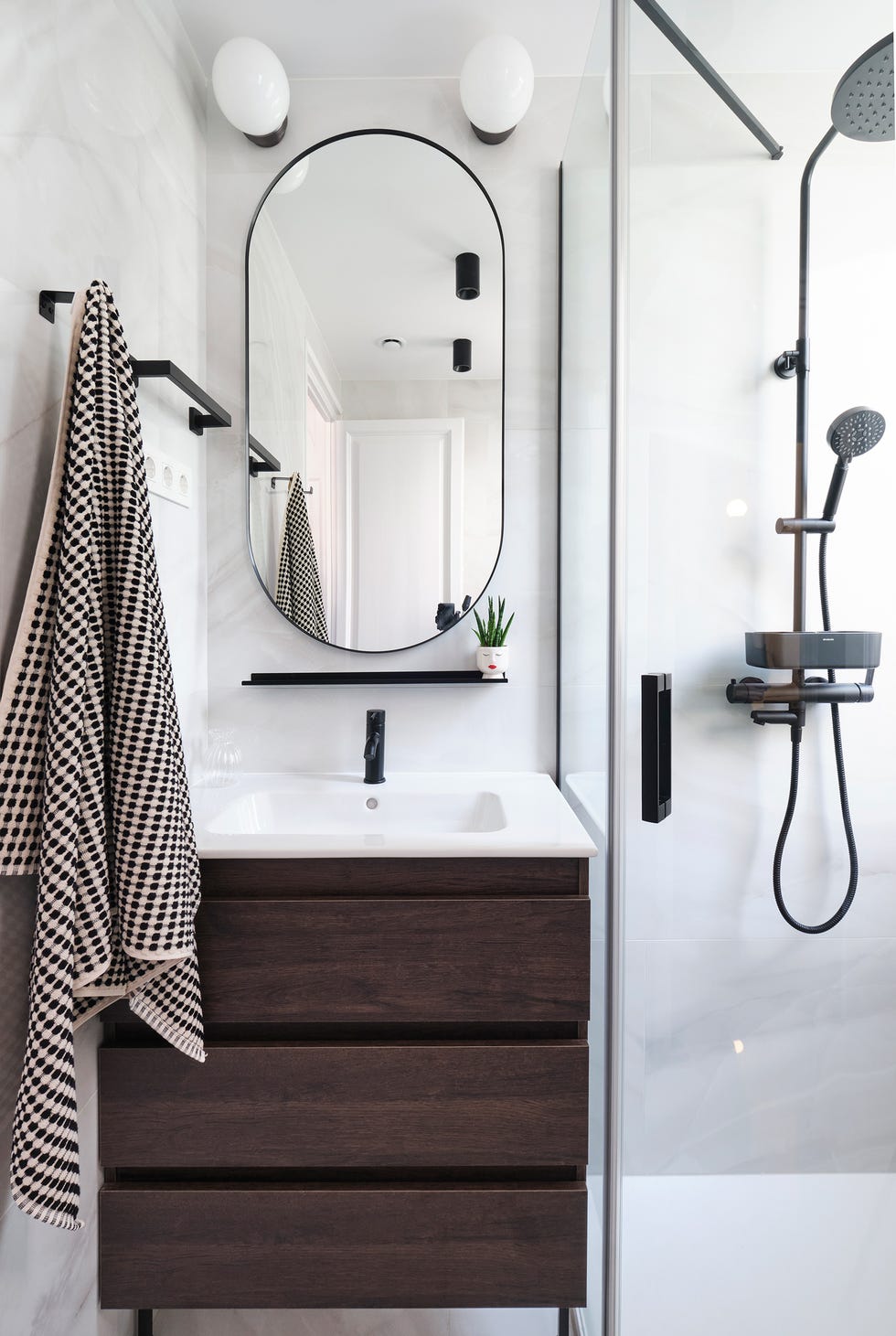baño con revestimientos de mármol y mueble de madera