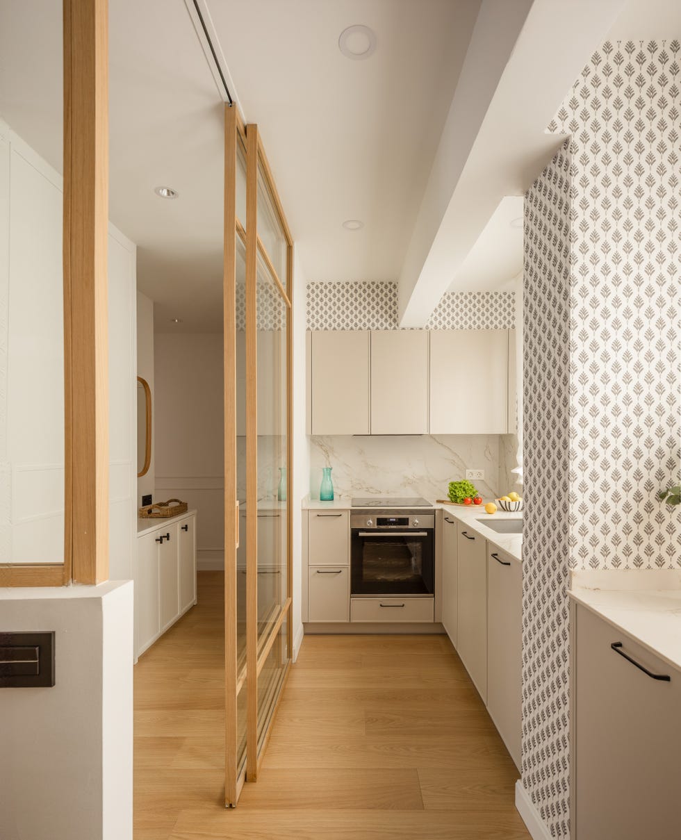 cocina abierta con puertas correderas de cristal y perfilería de madera