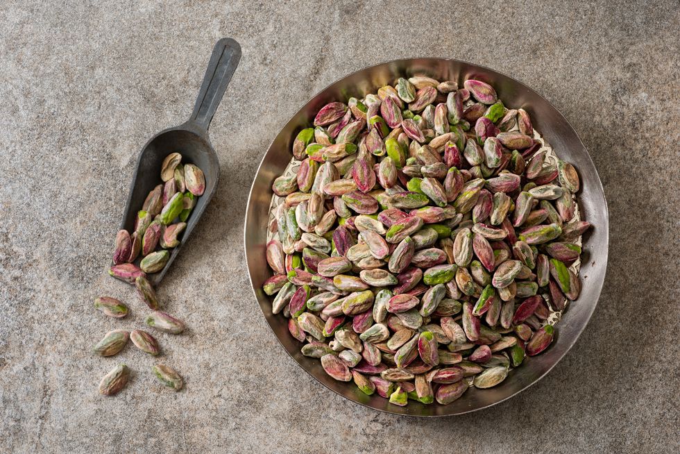 pistachio nut seeds no shells on a rustic background