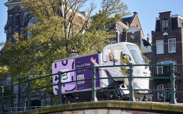 delivery vehicle on a canal bridge in an urban setting