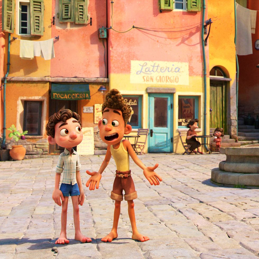 two italian kids talk in a town square in a scene from luca