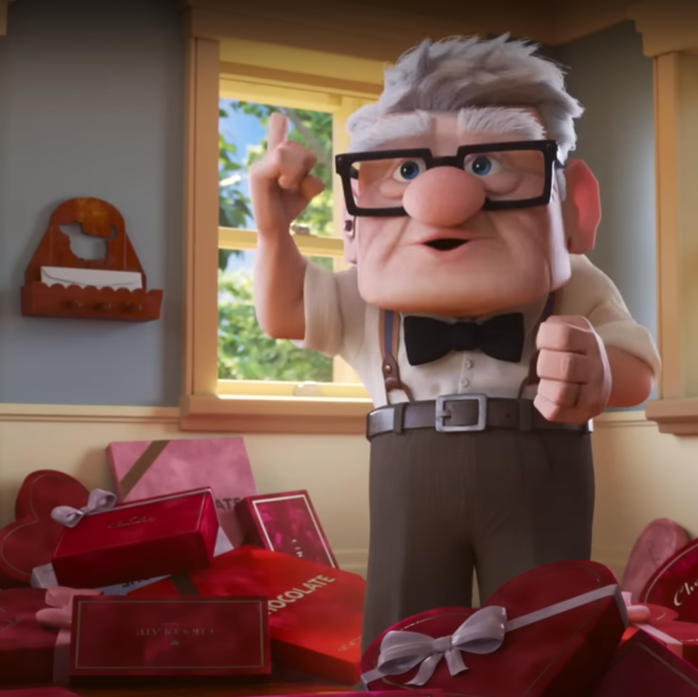 carl from up looking excited surrounded by red boxes of chocolate heart shapes