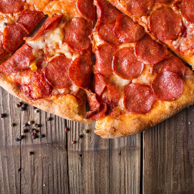 Pizza salami on wooden background