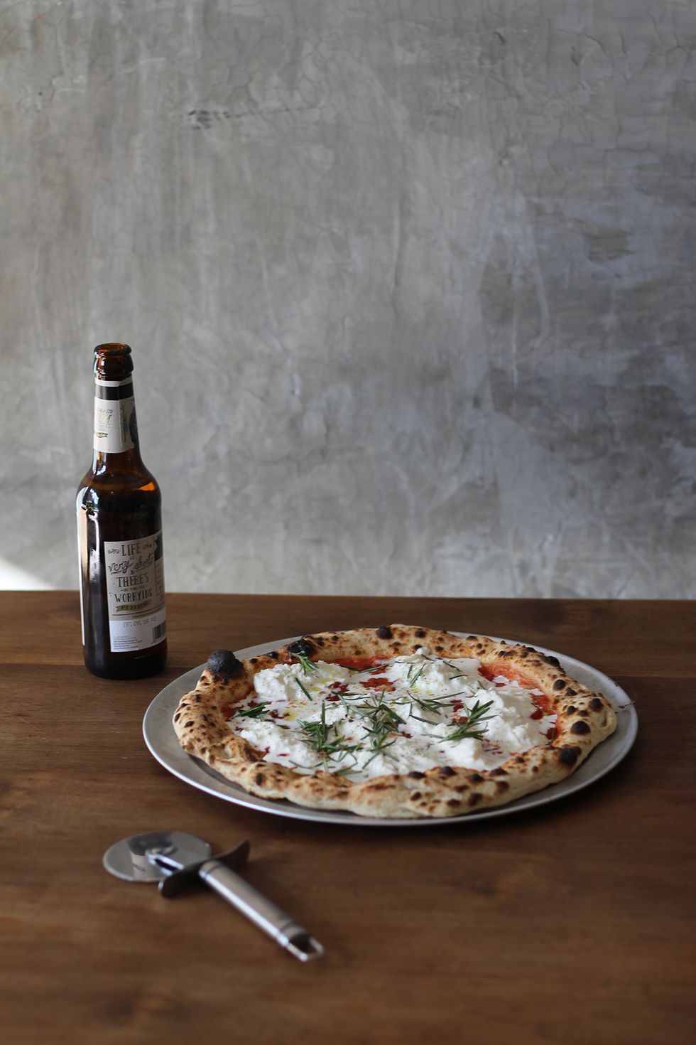 a pizza and a beer on a table