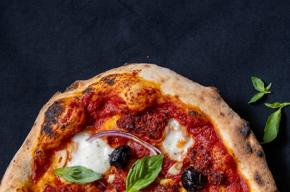 pizza with tomato sauce, mozzarella, nduja, olives, and garlic