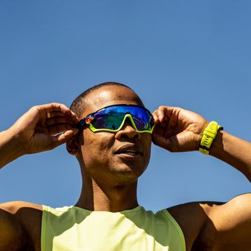 coach pj thompson wearing wrap around sunglasses before a run