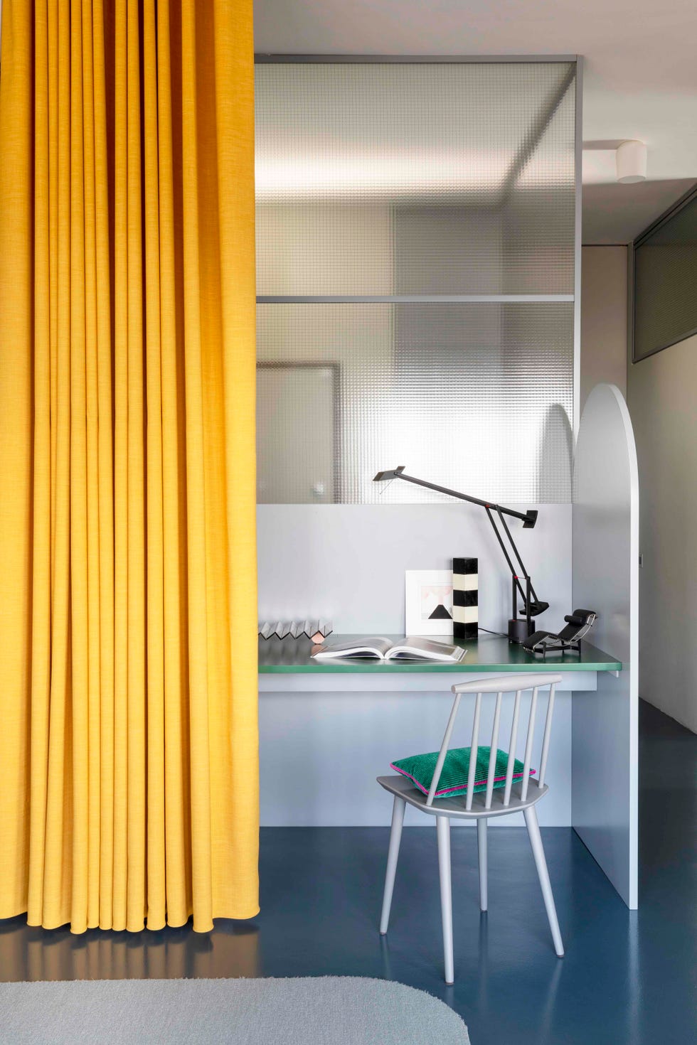 Colourful curtains cleverly divide this Turin home