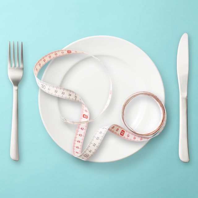 place setting with measuring tape on light blue background