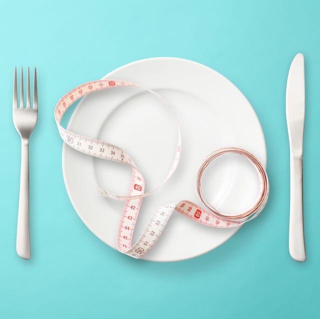 place setting with measuring tape on light blue background