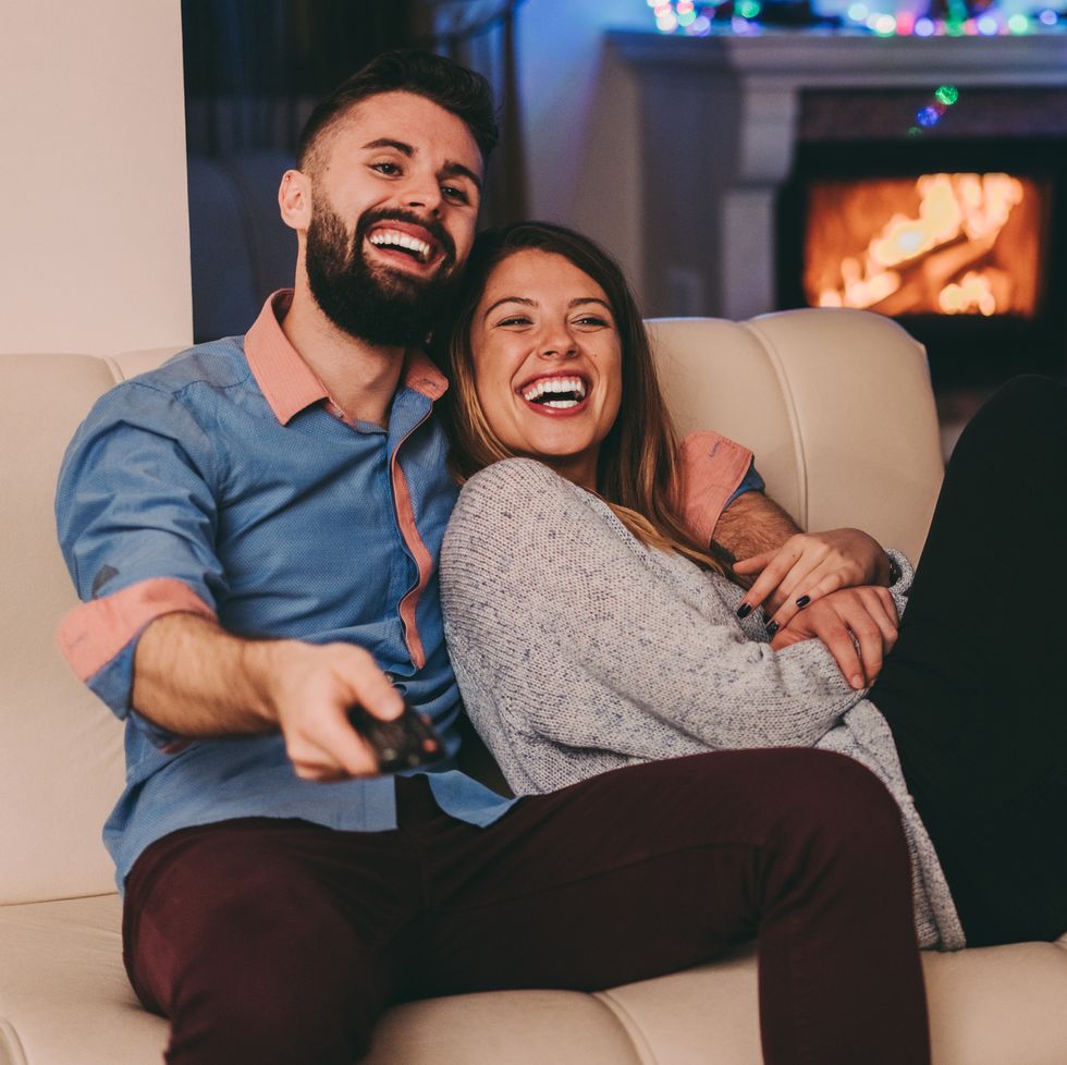 couple in home watching tv at christmas