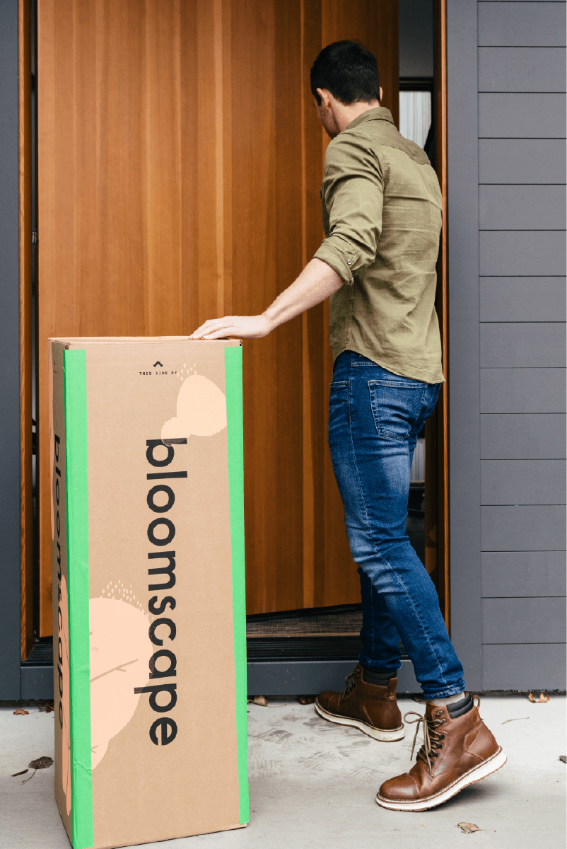 Man in front of door with a Bloomscape box
