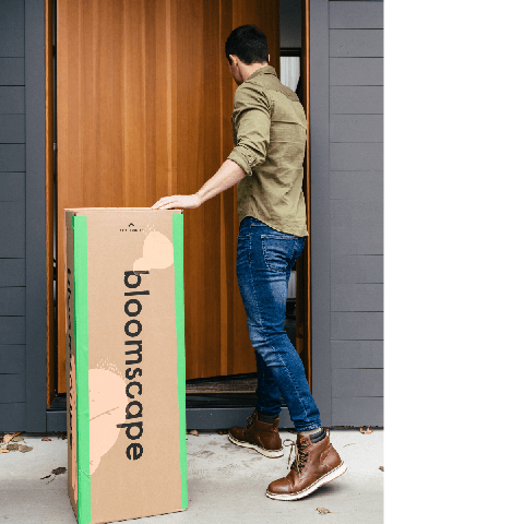 Man in front of door with a Bloomscape box