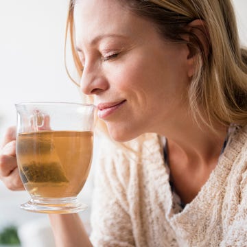 a woman drinking a glass of beer