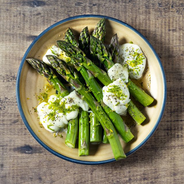 plate of asparagus salad on wooden background