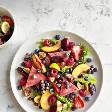 plate of fruit salad on white, marble background