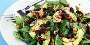 a plate of healthy avocado almond spinach salad