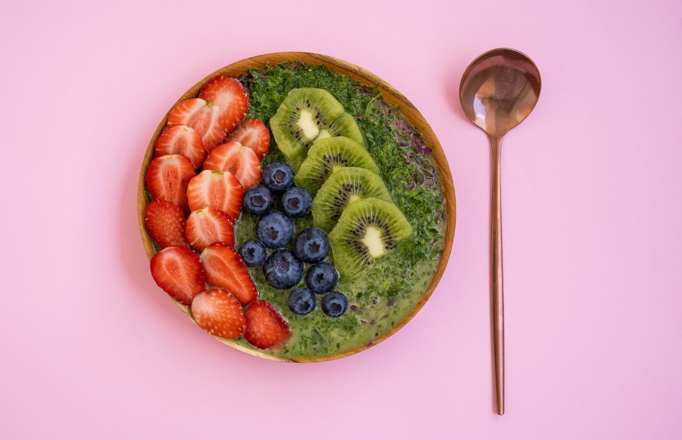 plate of smoothie made of strawberry, kiwi and blueberry