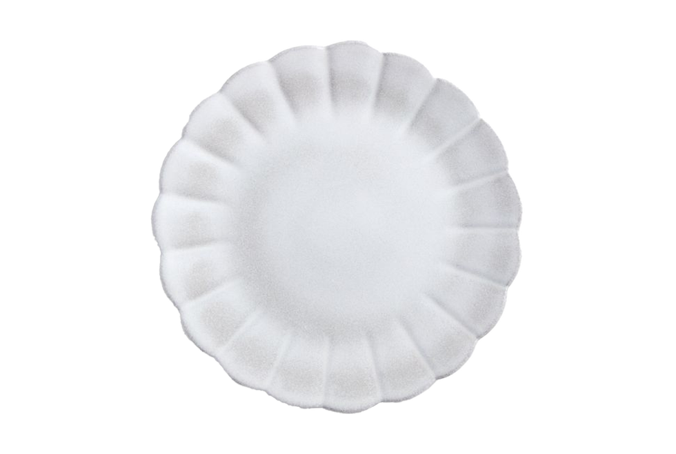 textured white plate with a scalloped edge