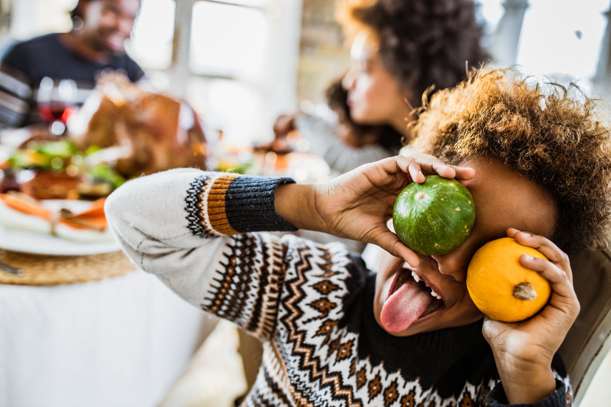 https://hips.hearstapps.com/hmg-prod/images/playful-black-girl-having-fun-with-small-pumpkins-royalty-free-image-1659046676.jpg?crop=1xw:0.84415xh;center,top