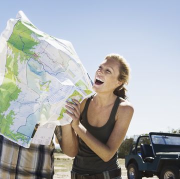 playful couple looking at map