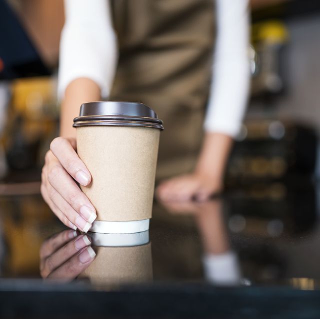 please enjoy drinking a coffee. the unrecognizable waitress serving coffee to a customer in a cafe. serving food and drink, point of sale system.