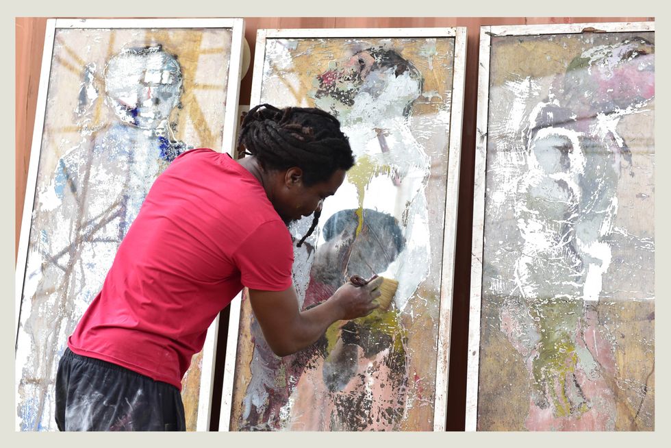 togolese artist sadikou oukpedjo paints in his workshop in bingerville, outside abidjan, ivory coast