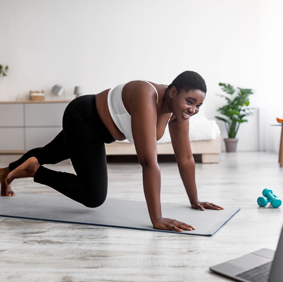 Premium Photo  Positive plus size african woman training with personal  trainer do abs sitting on yoga mat