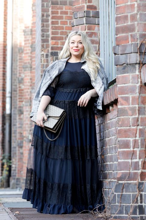 berlin, germany   january 12 german presenter, curvy model and plus size influencer wearing a dark blue dress with ruffles and a jeans jacket by marina rinaldi, a gucci purse and brown suede boots by zara during a street style shooting at berlin fashion week on january 12, 2020 in berlin, germany photo by isa foltingetty images