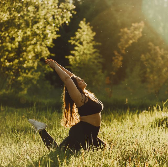 plus size girl doing yoga in nature