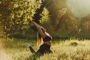 plus size girl doing yoga in nature