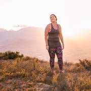 Plus size woman wearing sports clothing on mountain at sunrise Plus size woman wearing sports clothing on mountain at sunrise