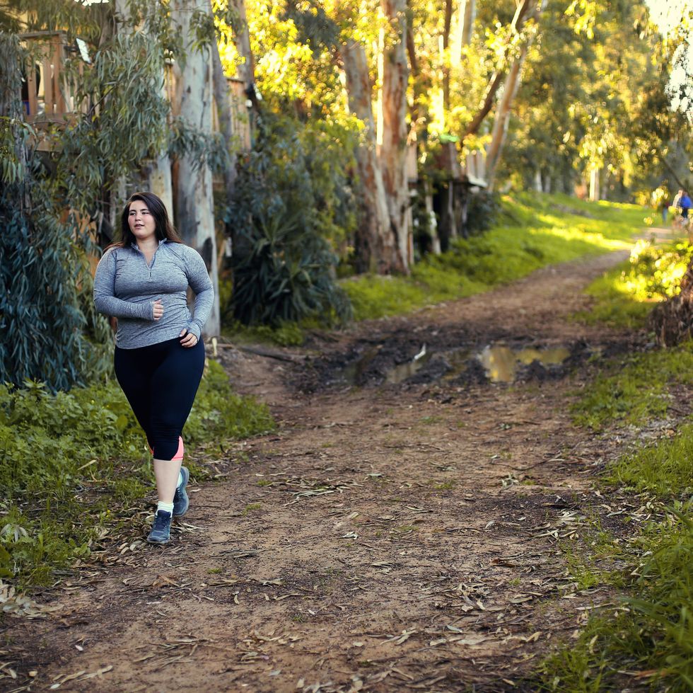 staycation ideas - Plus size women jogging and exercising at the park