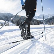close up of a mans legs doing cross country skiing in the dolomite alps