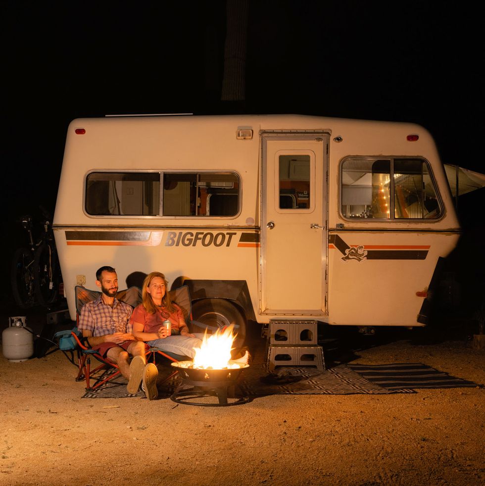 jeff and allie having a campfire in front of the 1981 bigfoot with jeff and allie inside in marana, az on march 3rd, 2022