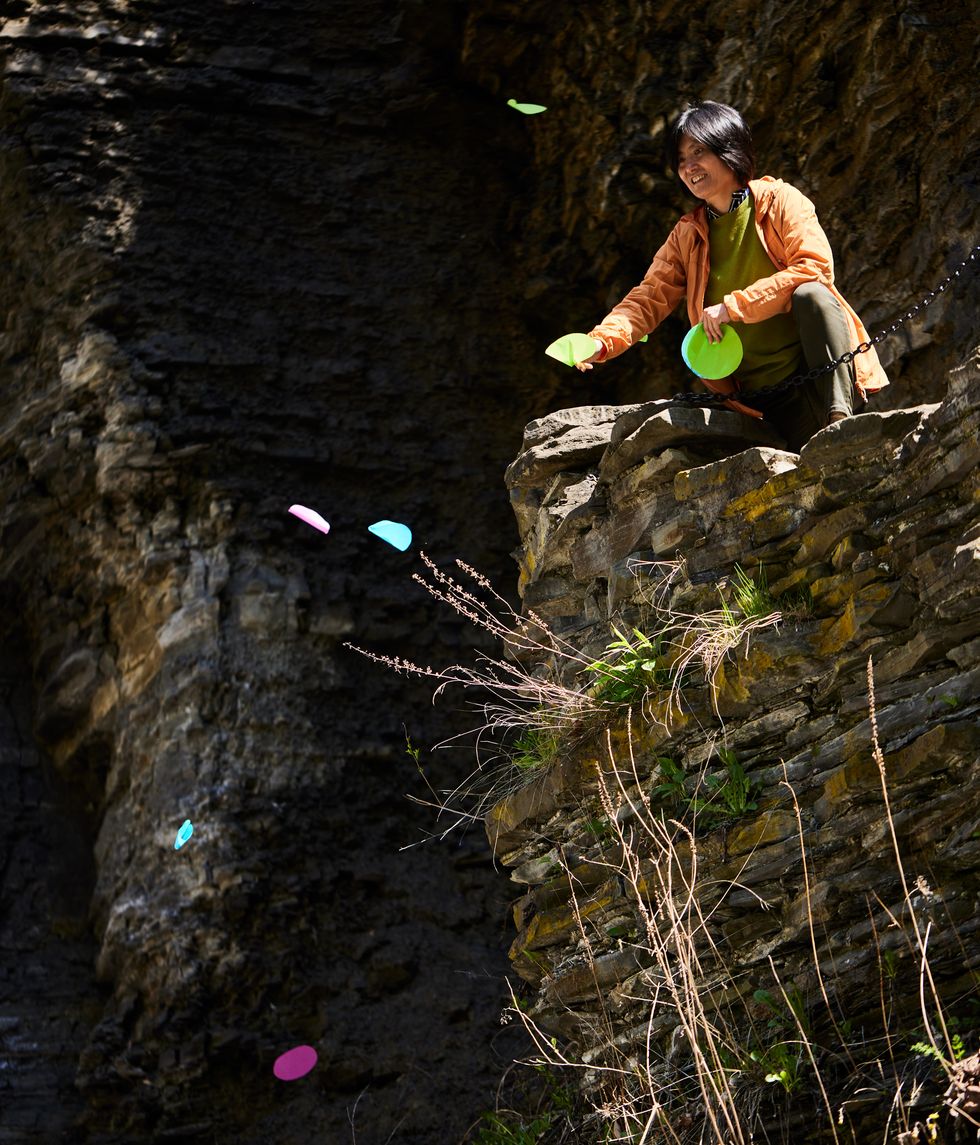 cornell professor jane wang drops different pieces of paper at a gorge in ithaca new york