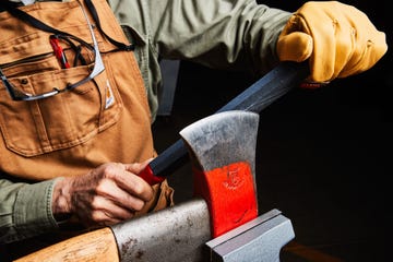 man sharpening axe