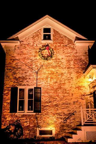kh3bb6 christmas wreath on a historical brick house at night with a spotlight, cranbury, new jersey, usa, vintage colonial christmas house garden snow