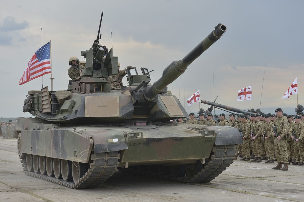 members of the british units watch passing us tank abrams during the opening ceremony of the exercise noble partner 16, a georgian, british and us military training exercise taking place at vaziani training area, georgia, may 11 26, 2016exercise noble partner includes approximately 500 georgian, 150 united kingdom and 650 us service members who are incorporating a full range of equipment, including us m1a2 abrams main battle tanks, m2a3 bradley infantry fighting vehicles, m119 light towed howitzers and several wheeled support vehicles alongside us forces, georgian forces will operate their t 72 main battle tanks, bmp 2 infantry combat vehicles and several wheeled support vehicleswednesday, 11 may 2016, in vaziani, georgia photo by artur widaknurphoto via getty images