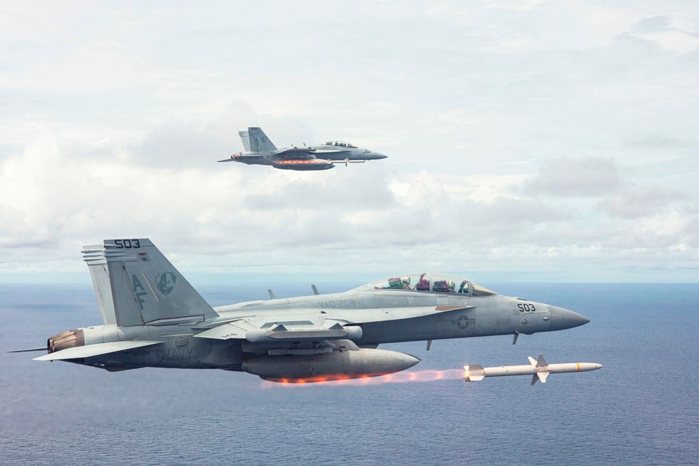 us navy ea 18g growler fighter aircraft attached to the star warriors of electronic attack squadron 209 firing agm 88 high speed anti radiation missiles