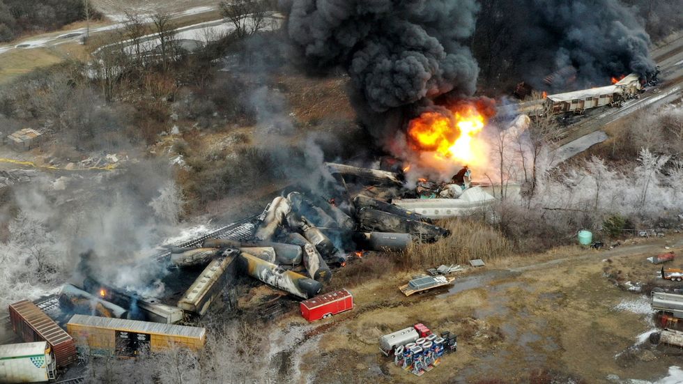 a fire burning in train pile up
