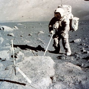astronaut on moon collecting samples