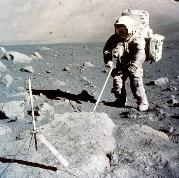 astronaut on moon collecting samples