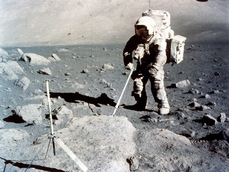 astronaut on moon collecting samples