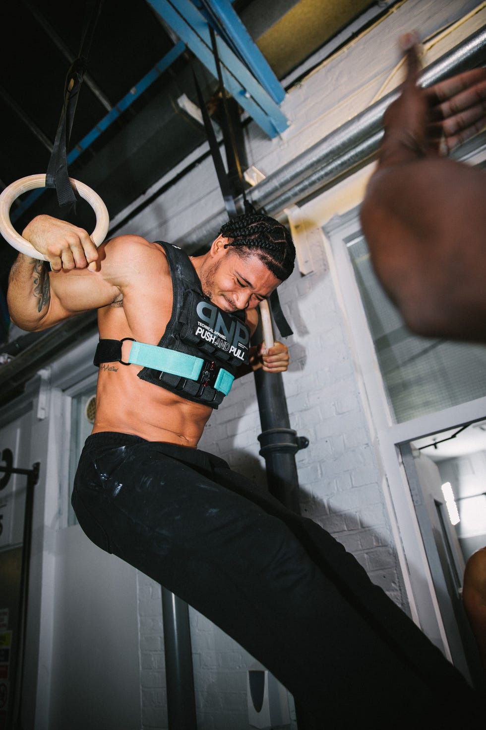 individual performing a muscleup on gymnastic rings