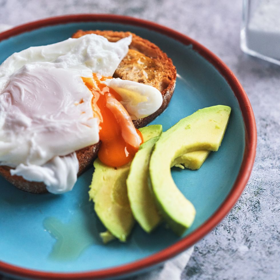 poached egg on brown bread served with avocado