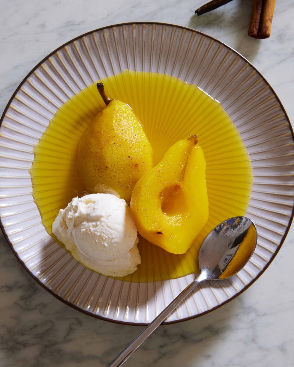 golden poached saffron pears with vanilla ice cream