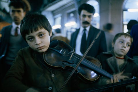 In this picture from the October 1973 issue young boys play the violin and tambourine along Istanbuls Flower Passagea street lined with bars and restaurantsin an effort to earn some money