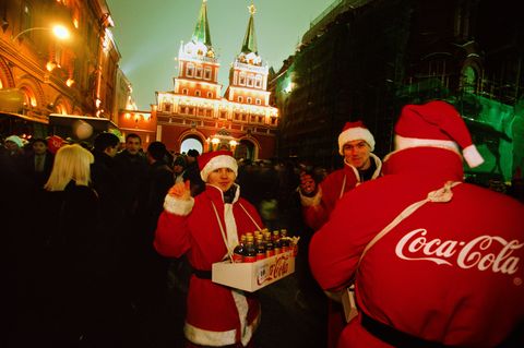 Dressed up like Santa three young men sell CocaCola at a New Years Day celebration in the streets near Moscows Red Square This photo appeared in the November 2001 issue commemorating the 10year anniversary of the USSRs breakup