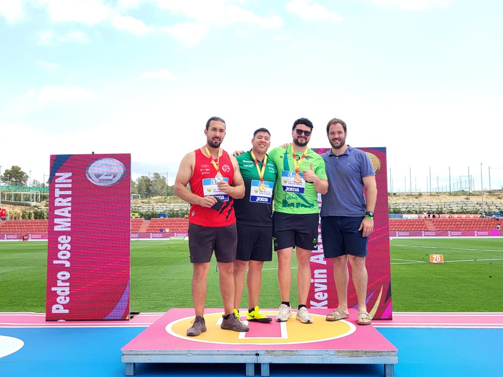 a group of men posing for a picture on a podium