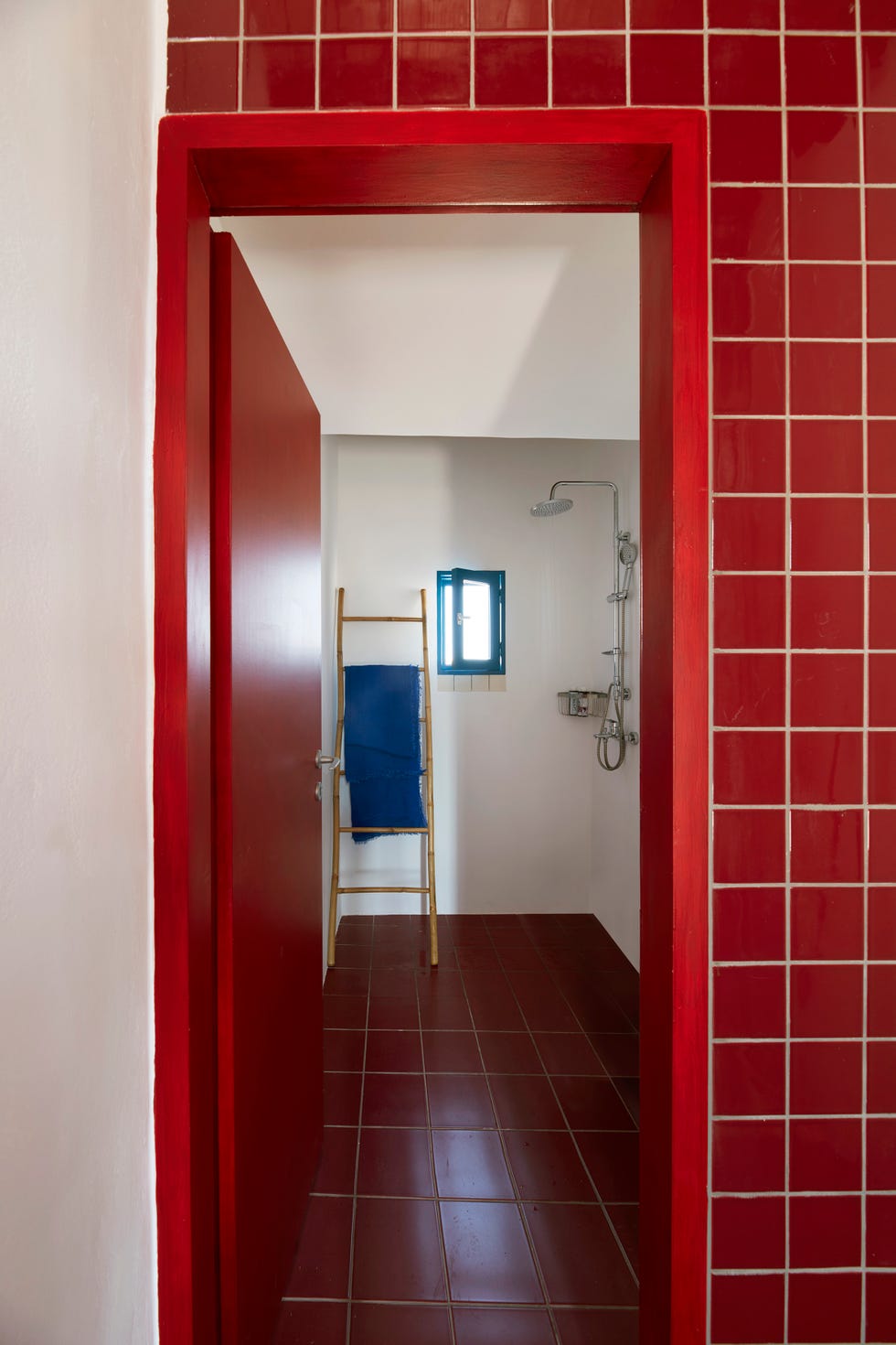 square red tiles in the bathroom of this greek home by point supreme architects